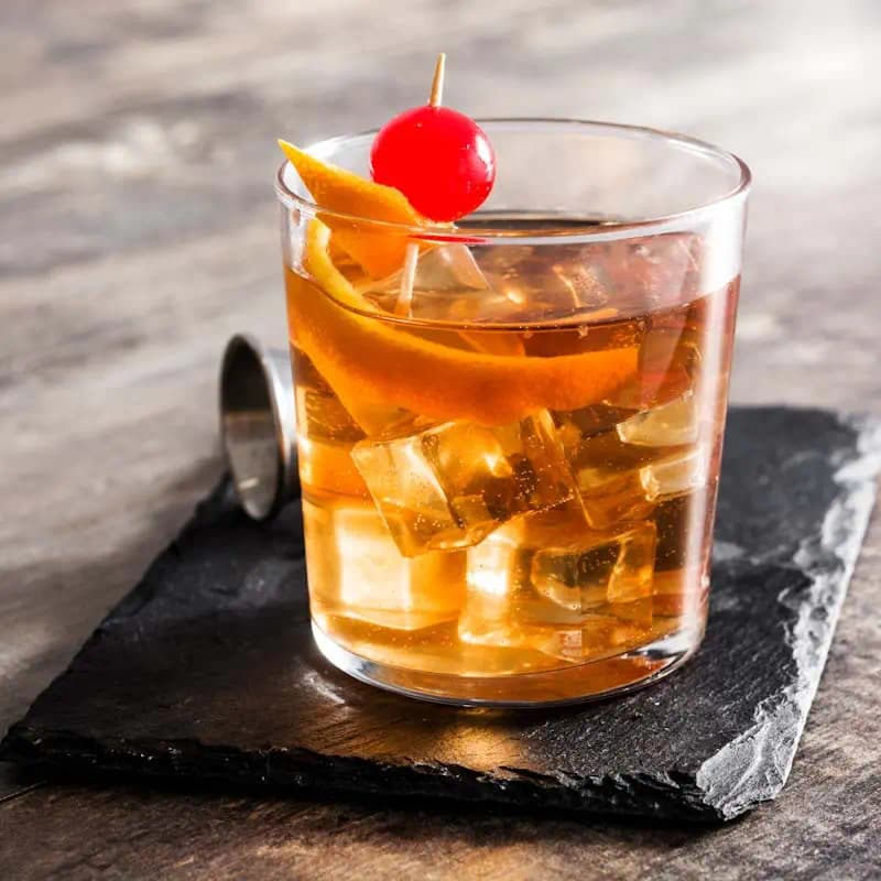 Old Fashioned Cocktail in a rocks glass with orange twist garnish