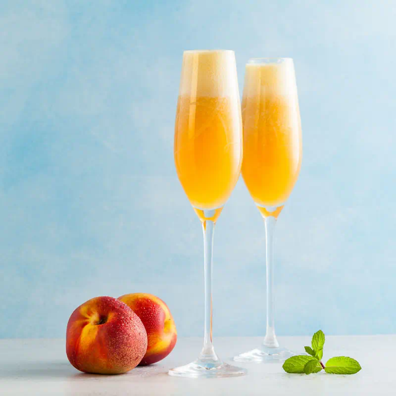 Peach Bellini cocktail in a champagne flute
